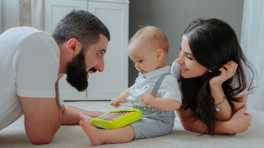 parents-playing-with-child-floor